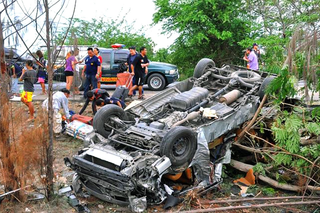 The overturned van struck a tree after skidding. Photo: Thai Rath