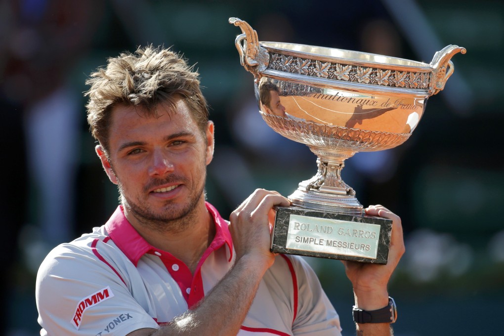 Stan Wawrinka of Switzerland poses with the trophy after winning the men's singles final against Novak Djokovic of Serbia. Photo: Reuters