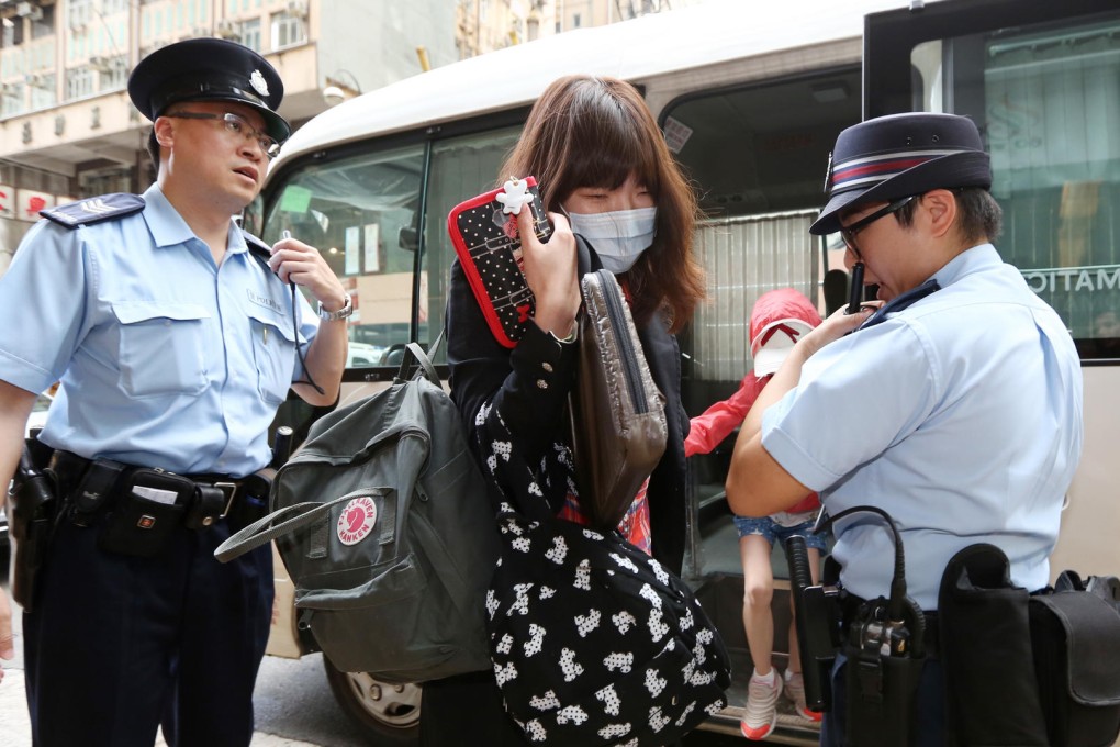 A Korean woman and a young girl leave one of the buses at the 60 West hotel in Sheung Wan after their quarantine. Photo: Nora Tam