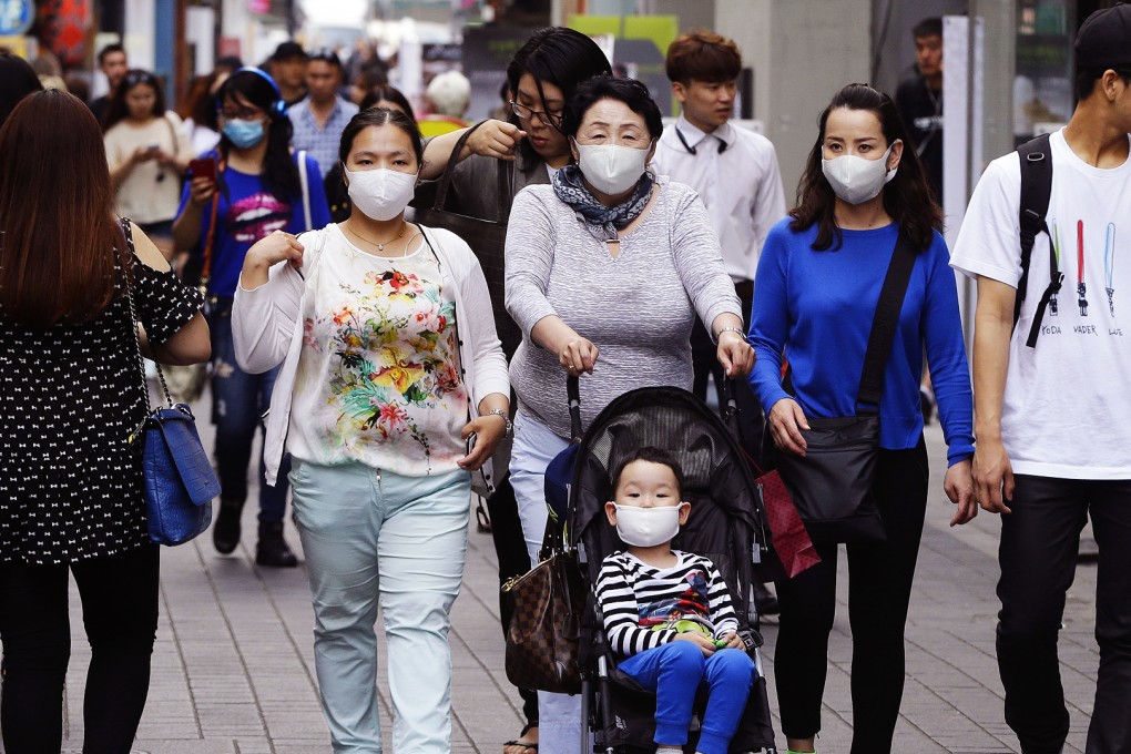 Foreign tourists wear masks as a precaution against Middle East Respiratory Syndrome on the Myeongdong, one of the main shopping districts, in Seoul. Photo: AP
