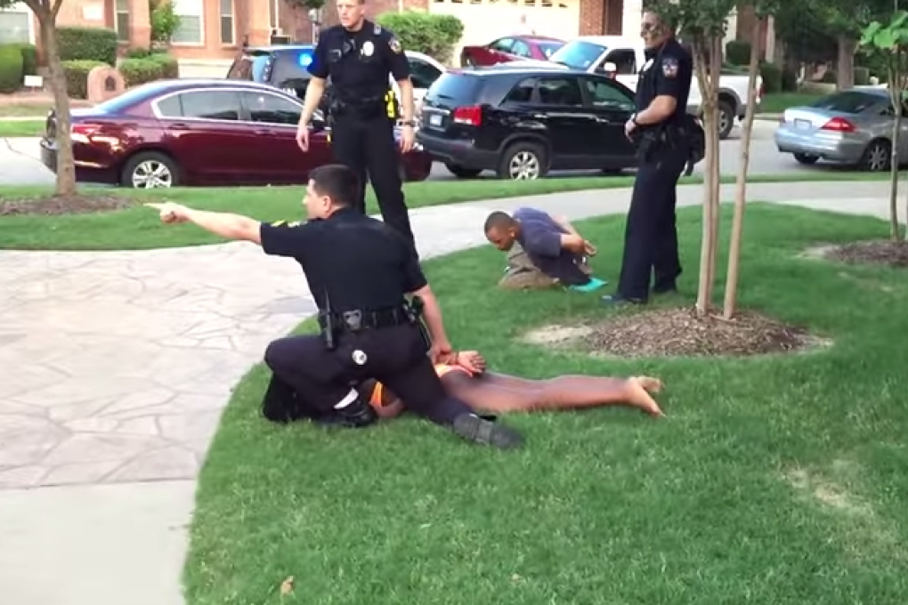 Eric Casebolt, responding to a reported disturbance at a suburban swimming pool, pins a girl to the ground while yelling at other teens to stay back, in video shot by a bystander. Photo: YouTube