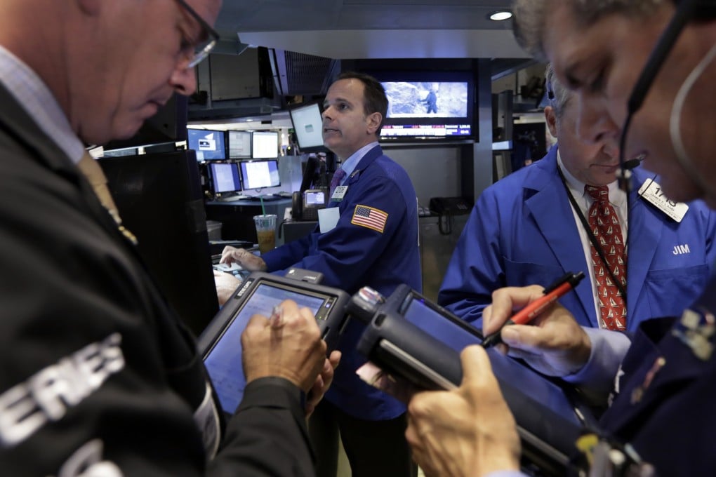 Wall Street traders break out their order pads as financial markets saw choppy dealings and a flat finish. Photo: AP