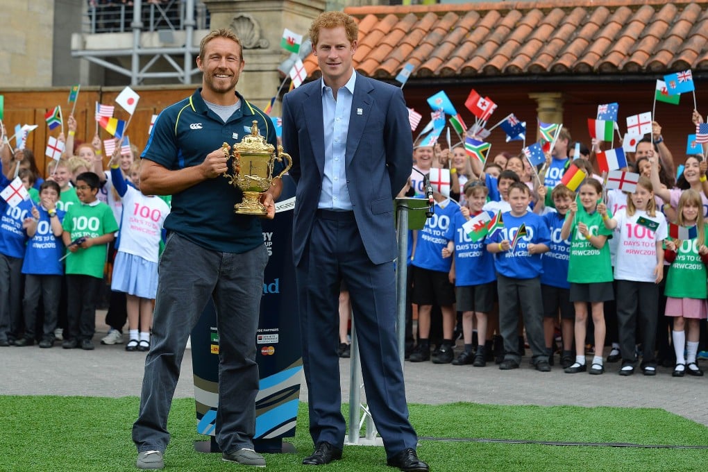 Jonny Wilkinson, the drop-goal hero of England’s 2003-winning World Cup team, and Prince Harry with the Webb Ellis Cup during a ceremony to mark 100 days to the start of the 2015 Rugby World Cup at Twickenham in London. Photo: AFP