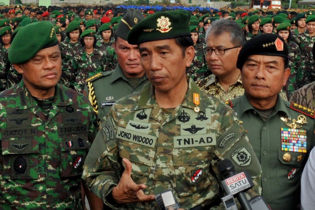 Indonesian President Joko Widodo (centre), in full military uniform, standing with General Gatot Nurmantyo (left), whom he picked as the next armed forces chief. He will replace General Moeldoko (right), who retires next month. Photo: AFP