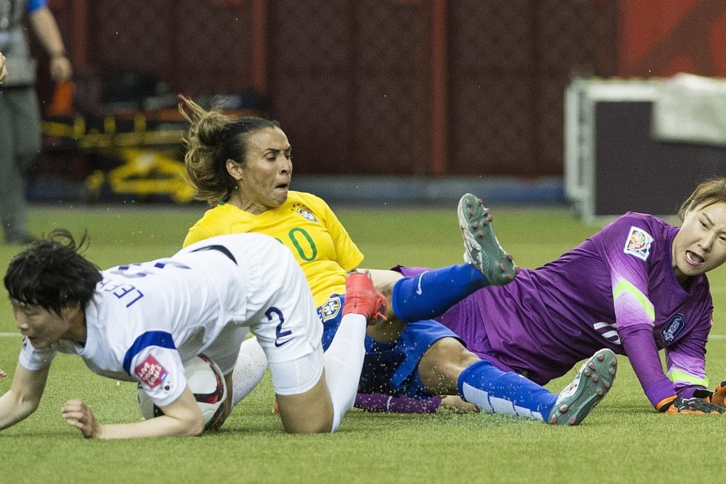 Brazil's Marta proves a handful for South Korea goalkeeper Kim Jungmi and defender Lee Eunmi during their Women's World Cup match in Montreal. Photos: AP