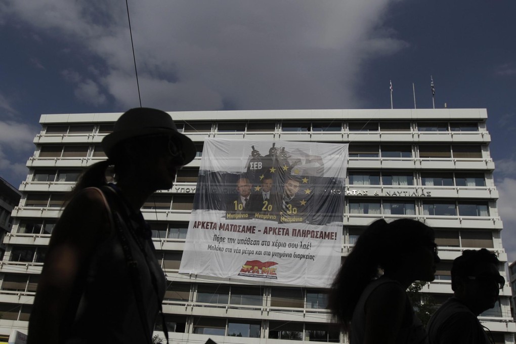 A protesters' banner hangs on Greece's Finance Ministry. Photo: EPA