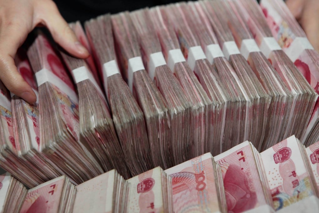 Stacks of China yuan bank notes are tallied in a bank as lender BNP Paribas calculated the chance of China collapsing under its debts at 15 per cent. Photo: AFP