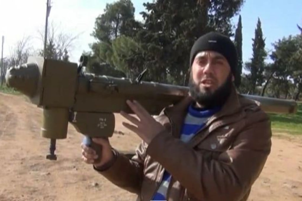 A member of the so-called Free Syrian Army, an anti-government group, demonstrates a Chinese FN-6 missile launcher that was used to shoot down a helicopter in 2013. Photo: YouTube