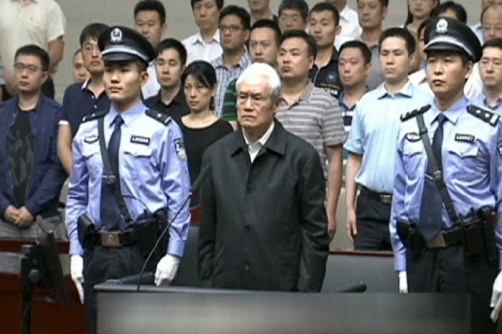 A white-haired Zhou Yongkang, China's former domestic security tsar, stands in court in Tianjin as he is sentenced on Thursday. Photo: Reuters