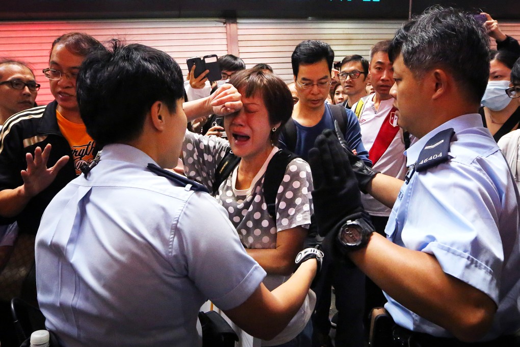 A woman cries during clearance operation in Mong Kok occupied site. Photo: Sam Tsang
