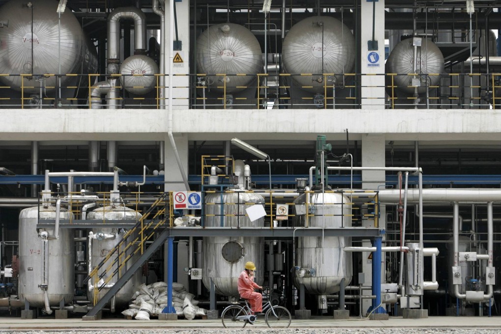 A worker cycles around a China National Petroleum Corporation factory in Lanzhou, Gansu province. Photo: Reuters