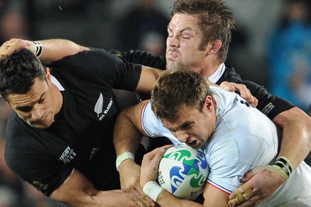 Dan Carter (left) and Richie McCaw (centre), seen here playing for the All Blacks against France, were given a fitting send-off to their New Zealand rugby careers Saturday when their Canterbury Crusaders side beat the Brumbies 37-24 in Canberra. Photos: AFP