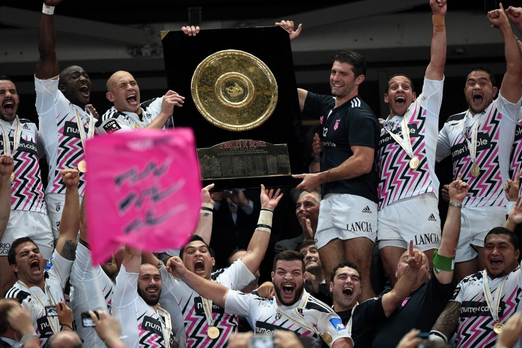 Stade Francais players celebrate with the Bouclier de Brennus trophy after winning the French rugby union final against Clermont Auvergne at the Stade de France. Photo: AFP