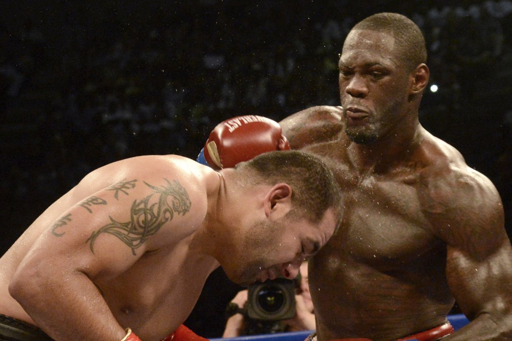 Deontay Wilder lands a punch against Eric Molina during their WBC heavyweight title fight at Bartow Arena in Birmingham. Photos: AP