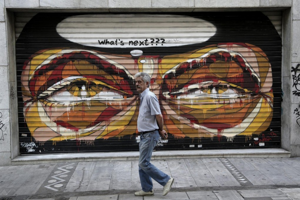 A man walks in front of a closed shop in Athens, Greece.Photo: EPA