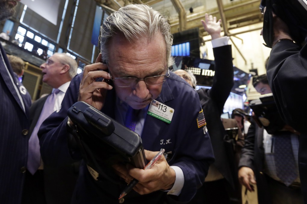 A trader on Wall Street listens intently on his cell phone as shares fell across the board due to a seeming deadlock in Greek debt talks. Photo: AP