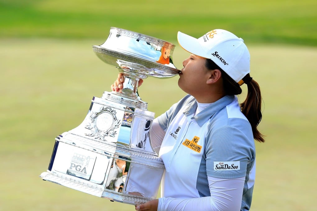 Park In-bee reacquaints herself with the Women's PGA Championship trophy. Photo: AFP