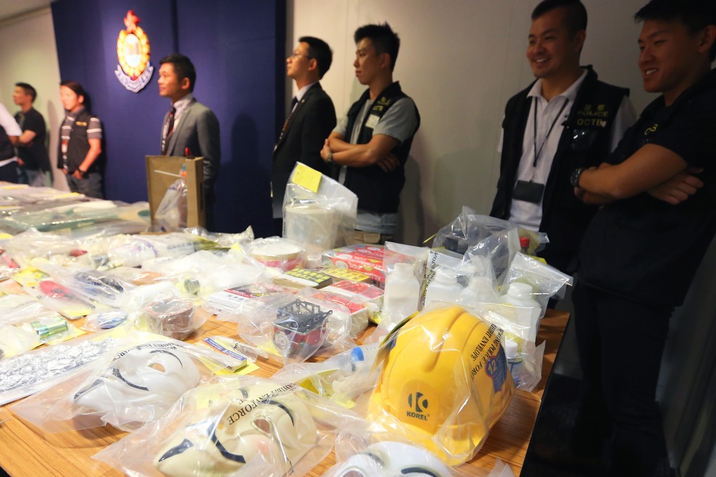 Police display material including Guy Fawkes masks seized in raids on Monday - but some social media users questioned if the bomb plot was real. Photo: David Wong