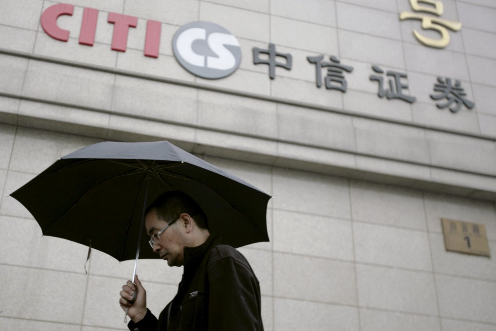 The Citic Securities branch in Beijing looms over a passersby as the mainland's largest brokerage hopes to raise HK$27.06 billion in a private placement, the second in a week in Hong Kong. Photo: Reuters