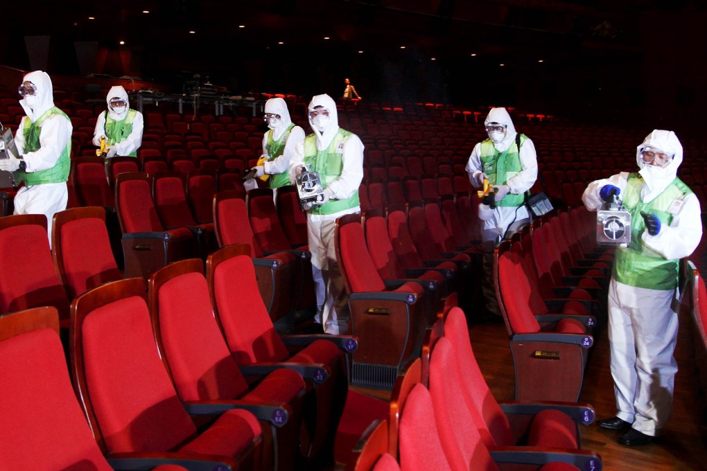 South Korean health workers fumigate a cinema in Seoul. Photo: EPA