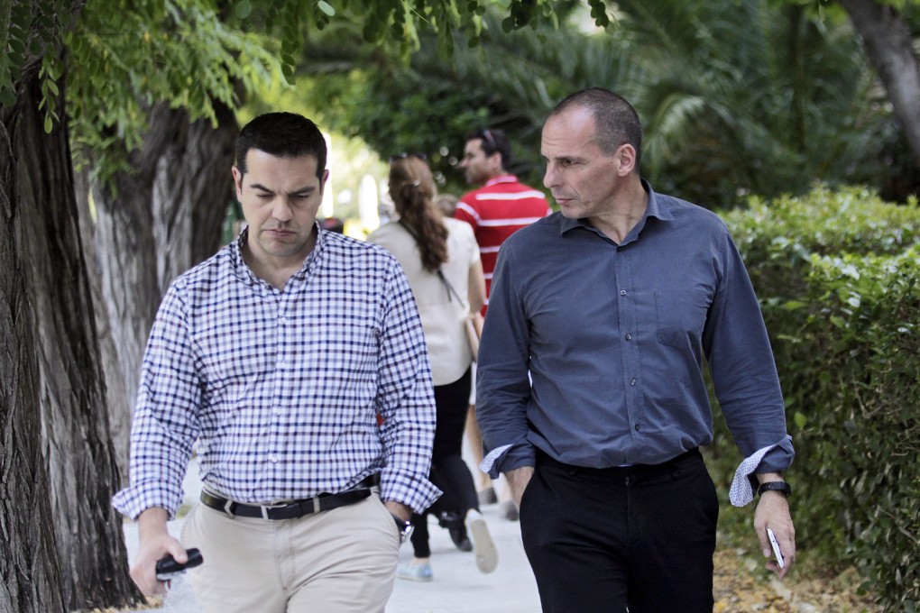 Greek Premier Alexis Tsipras (L) and Greek Finance Minister Yanis Varoufakis (R) take a walk in a park in Athens as their government blames creditors for the collapse of debt talks over the weekend. Photo: EPA