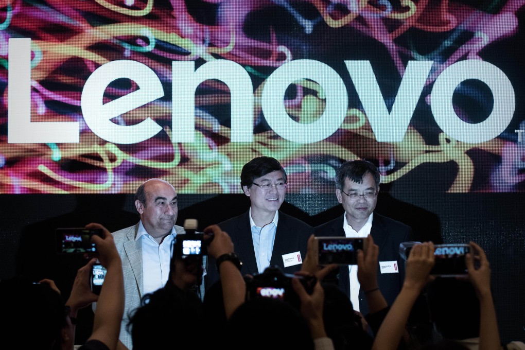The listing could spell good news for Lenovo CEO Yang Yuanqing (centre) by freeing up funds for Legend to buy more complementary subsidiaries. Photo: AFP