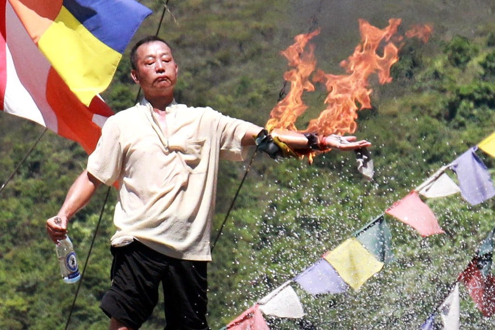 Lau Kin-kwok, chief of the Po Yin Fat Yuen monastery, set his left arm on fire. Photo: SCMP Pictures