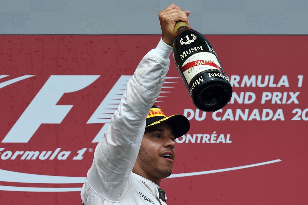 Lewis Hamilton reacts on the podium at the Circuit Gilles Villeneuve in Montreal after winning the Canadian Formula One Grand Prix. Photos: AFP