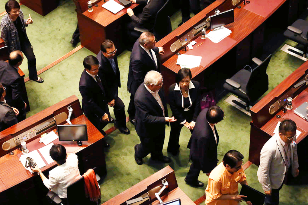 Pro-establishment lawmakers head for the exits moments before the crunch vote on electoral reform. Photo: Jonathan Wong