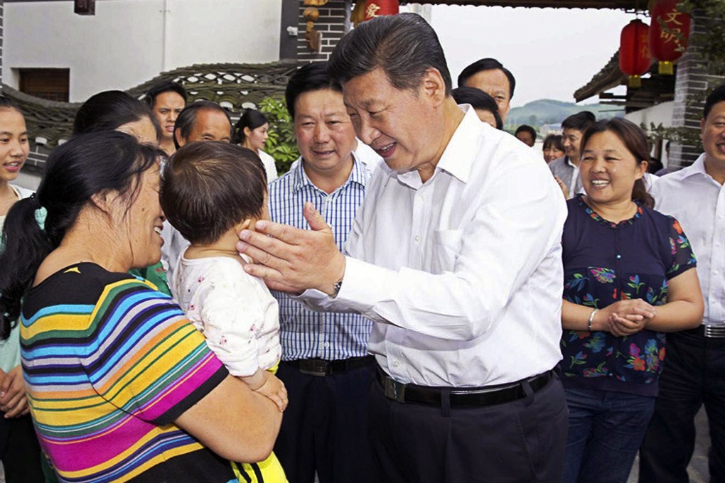 President Xi Jinping talks with villagers in impoverished Guizhou province's Huamao village to find out more about their daily lives. Photo: Xinhua