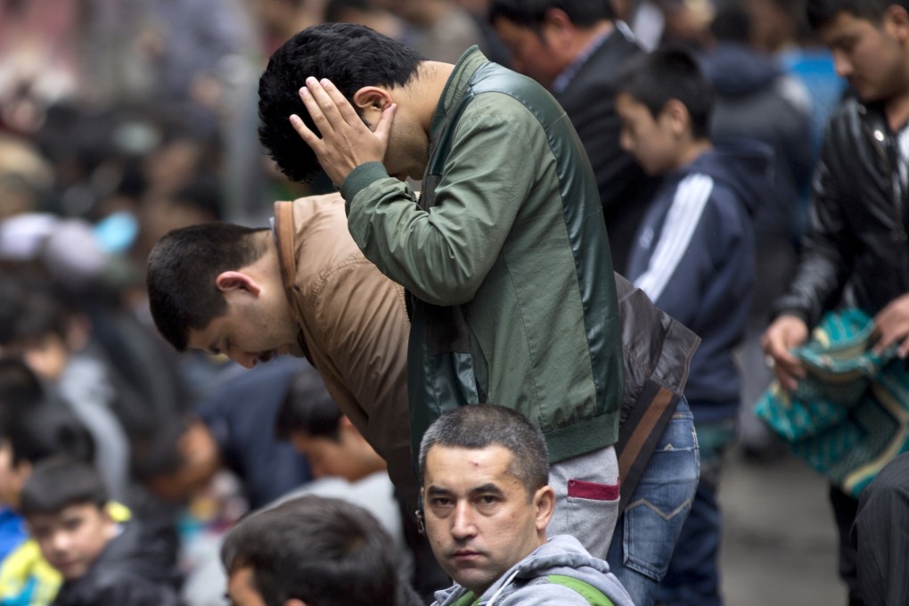 A file picture of Muslim Uygurs praying outside a mosque in Urumqi in Xinjiang. Photo: AP
