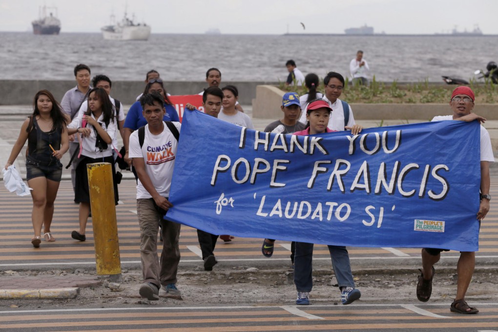 Environmental activists in Manila march towards a Roman Catholic church to coincide with Pope Francis' encyclical yesterday. Photo: AP