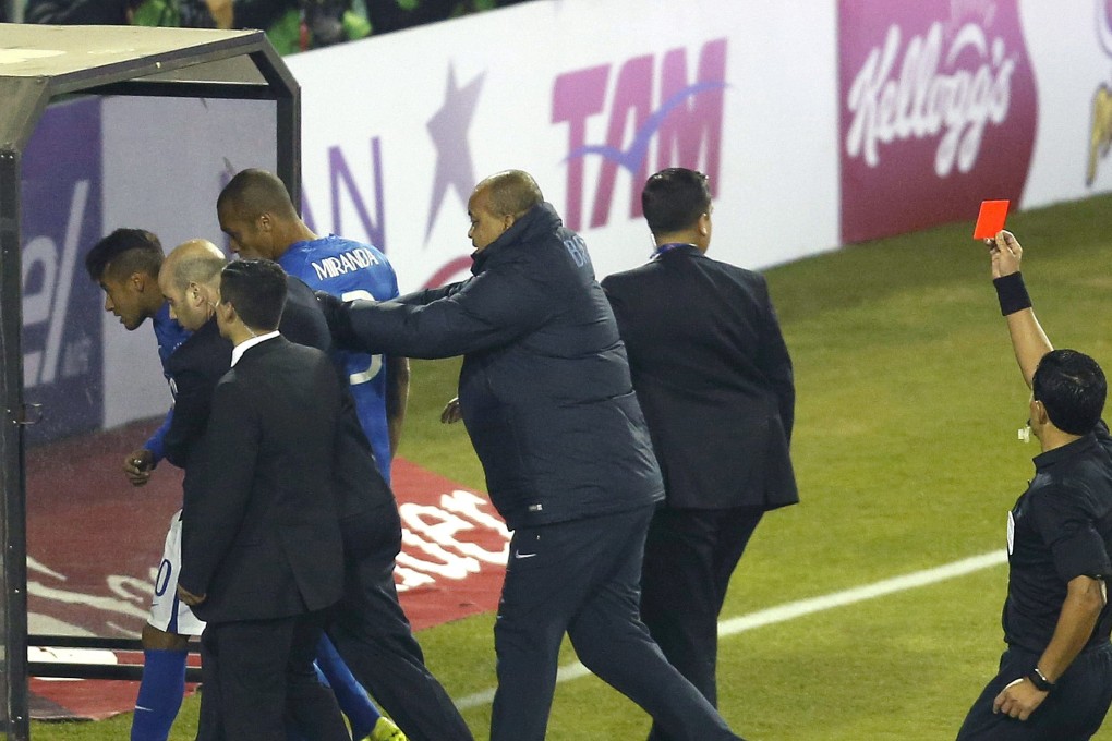 Referee Enrique Osses issues a red card to Brazilian striker Neymar. Photo: EPA