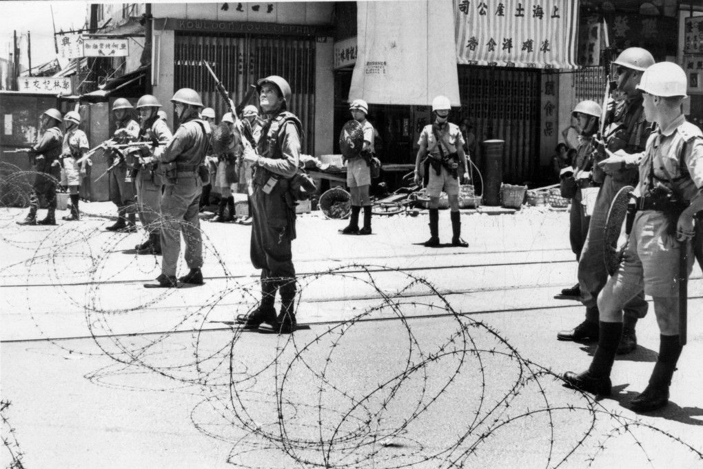 Soldiers and riot police stand behind barbed wire in 1967. Photo: SCMP Pictures