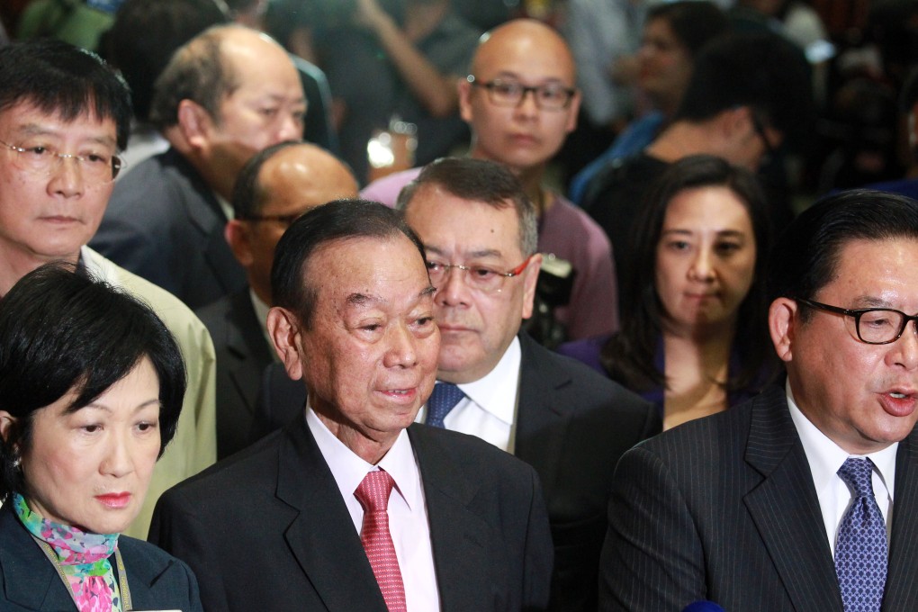 Whoops: Pro-Beijing legislators (front, from L-R) Regina Ip, Lau Wong-fat and Jeffrey Lam Kin-fung explain why they walked out of the chamber, leaving the reform proposal to be voted down by a landslide. Photo: May Tse