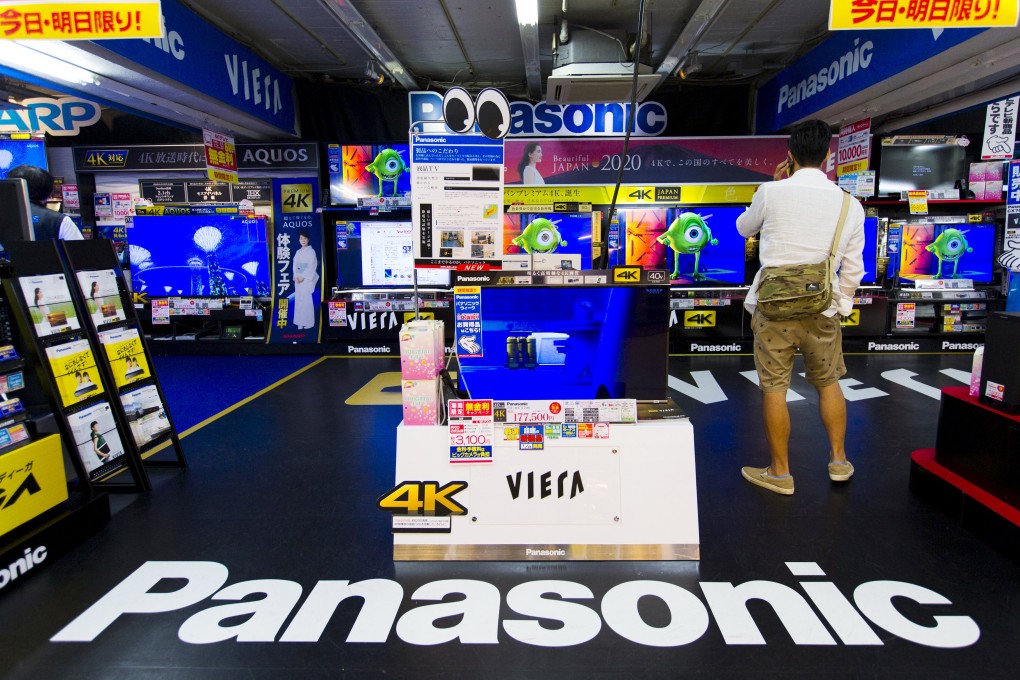 A man looks at TV sets of Panasonic, which along with Sony, said they will not quit the shrinking TV market. Photo: Reuters