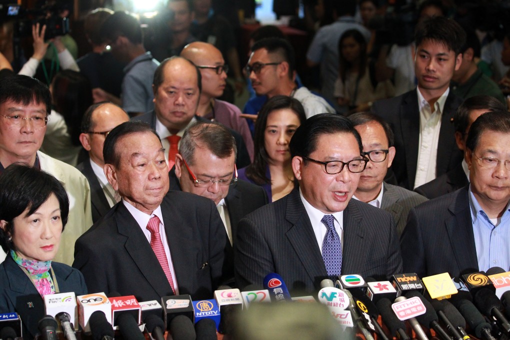 Lawmakers from the pro-Beijing camp struggle to explain why they left the chamber, leaving the reform package to be rejected by a landslide. Photo: May Tse