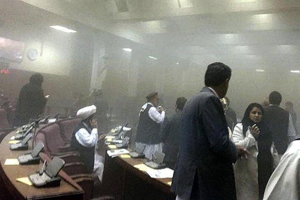 Members of Afghanistan's parliament evacuate the smoke-filled chamber after the Taliban launched an attack on the building in Kabul yesterday.Photos: SCMP Photos, Reuters