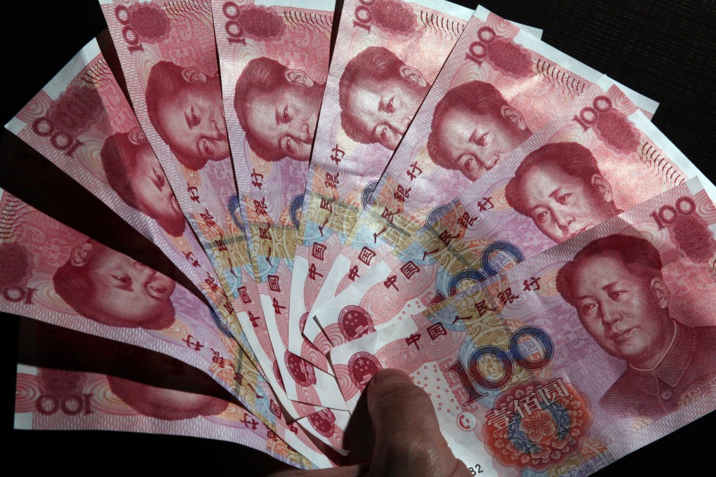 Yuan bank notes are arranged in a semi-circle as the currency in the spot offshore market as currency traders monitored developments in the Greek debt talks. Photo: EPA