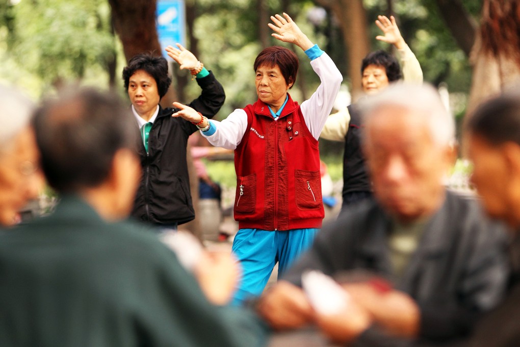 Old people playing cards while some exercising at a park in Guangzhou. The one-child policy has put a strain on the resources available to care for China's ageing population. Photo: Xinhua