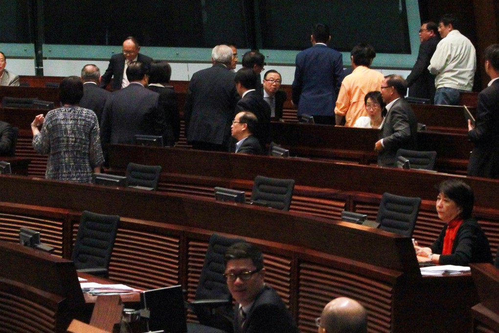 Pro-Beijing lawmakers file out of the Legco chamber on Thursday before the vote on electoral reform. Photo: May Tse