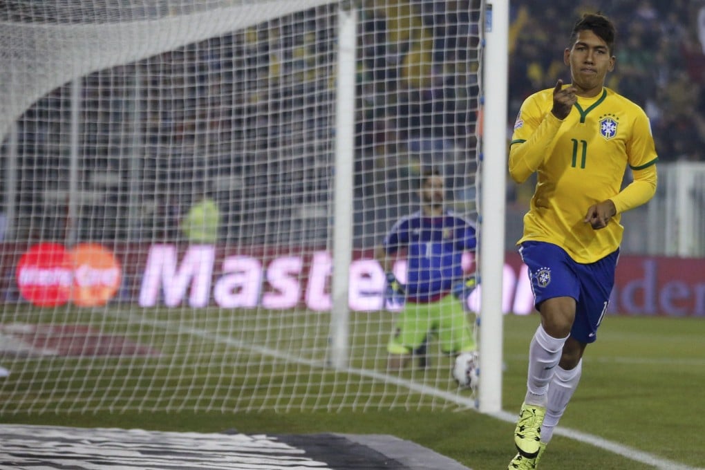 Brazil's Roberto Firmino scores past Venezuela's goalie Alain Baroja. Photo: Reuters