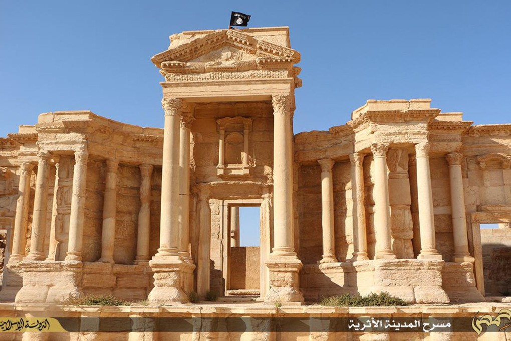 A black Islamic State flag flutters atop the ancient ruins of Palmyra, in this image made available by jihadist media outlet Welayat Homs last month. Photo: AFP