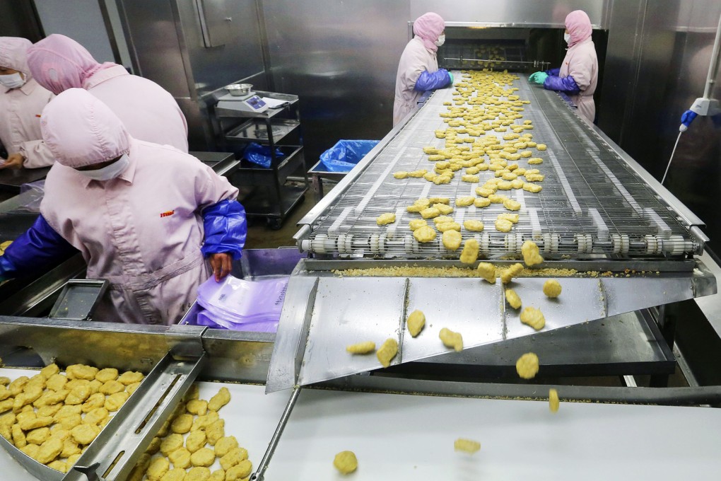 Employees work at a production line prior to inspections from the Shanghai Food and Drug Administration, at the Husi Food factory in Shanghai. Photo: Reuters