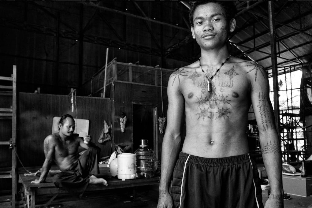 A student of tattoo master Teven Say (left) displays his ink in his mentor's studio in Siem Reap, Cambodia. Photos: Nathan Thompson; Emily Townsend
