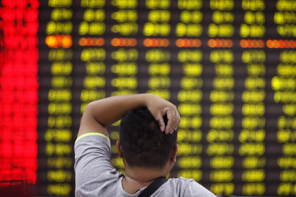 An investor in the Shanghai equities market ponders the wild swings in the index in volatile trading the past few sessions. Photo: AP