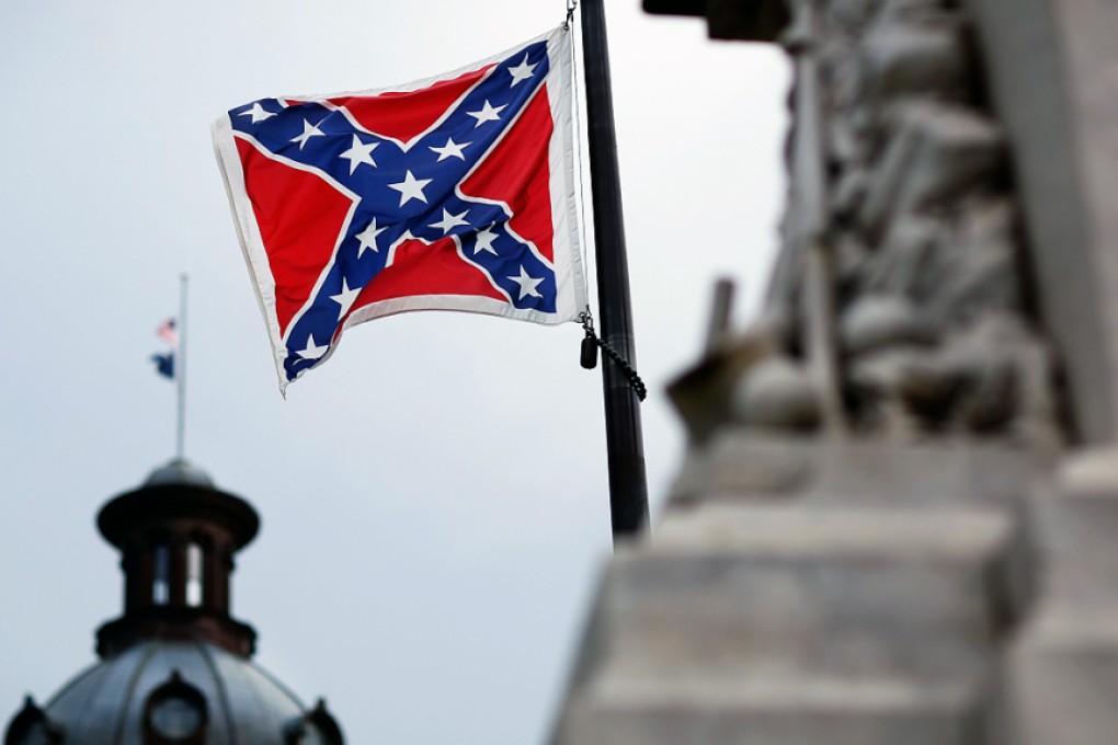 The Confederate flag flies on the grounds of the South Carolina Capitol building. There have been calls for its removal in the wake of a racist attack that left nine people dead. Photo: AFP