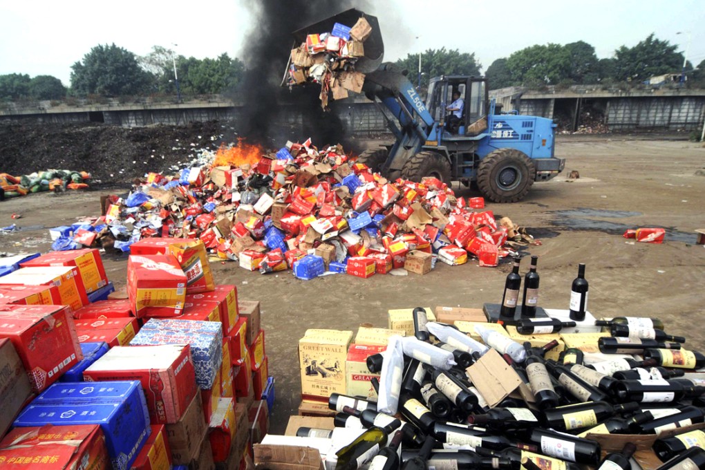 Fake wines are destroyed in China in this 2011 file picture. The country remains one of the world's largest sources of fake goods. Photo: Reuters