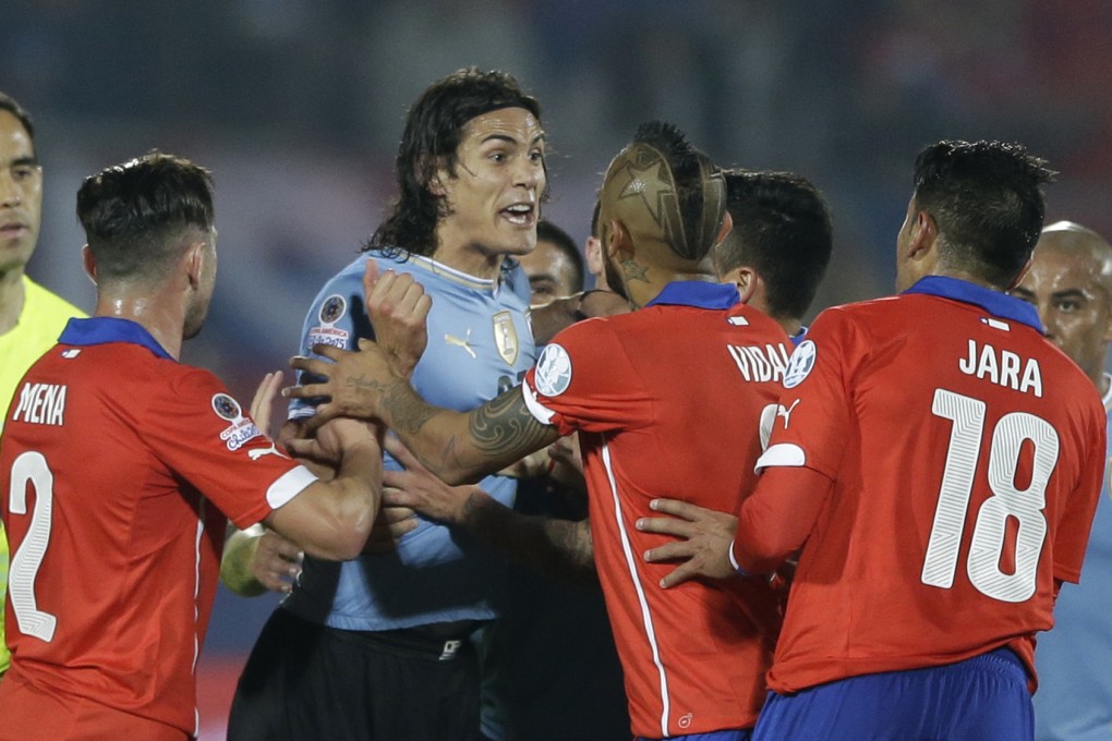 Edinson Cavani argues with Chile's Gonzalo Jara, 2nd right. Photo: AP
