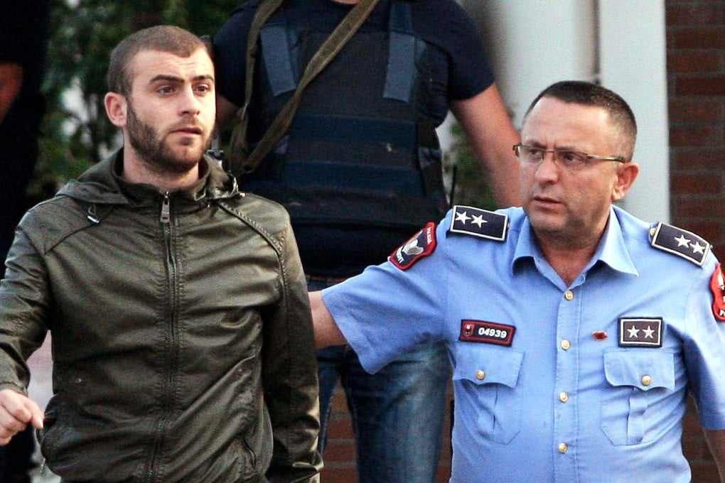 Albanian police detain a man. Photo: AFP